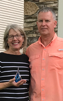 Donor couple holding their droplet sculptures